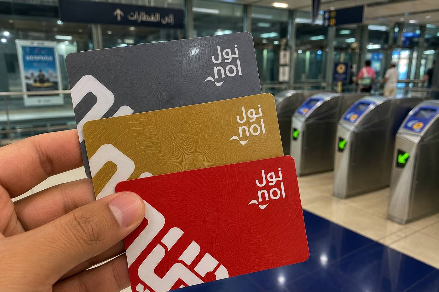 Silver and Gold Nol cards displayed with ticket vending machine at metro station